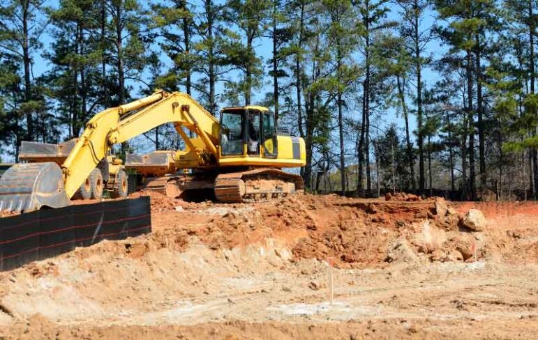 excavator working on a lot for custom home